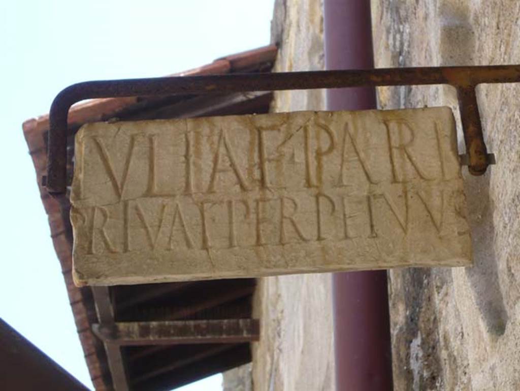 V.4 Herculaneum. August 2013. Marble plaque marking the property boundary belonging to JVLIAE PARIS.  This south side of the boundary marker would be for the property at V.3 and V.4.  Photo courtesy of Buzz Ferebee.